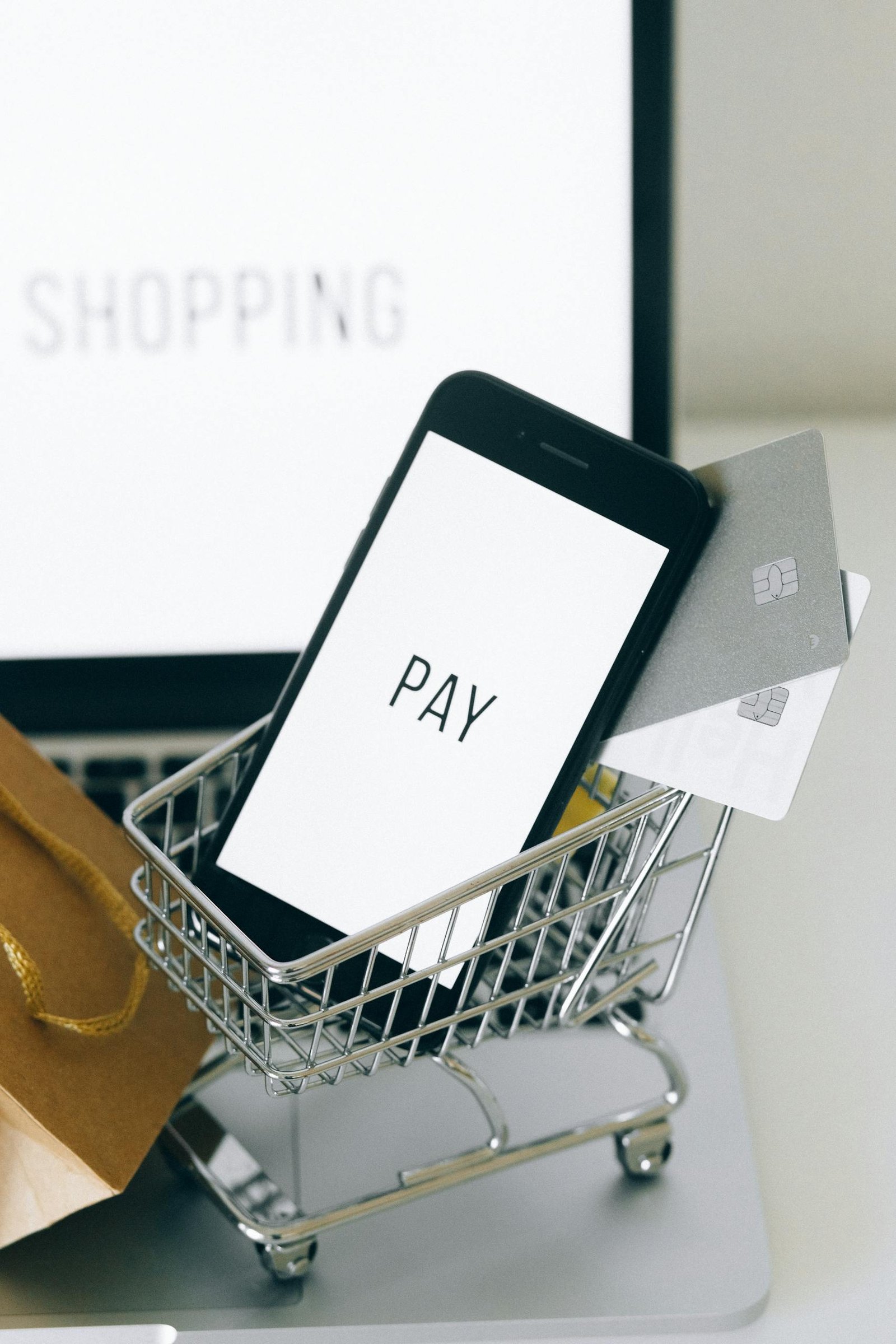 A Smartphone and Credit Cards in a Miniature Shopping Cart